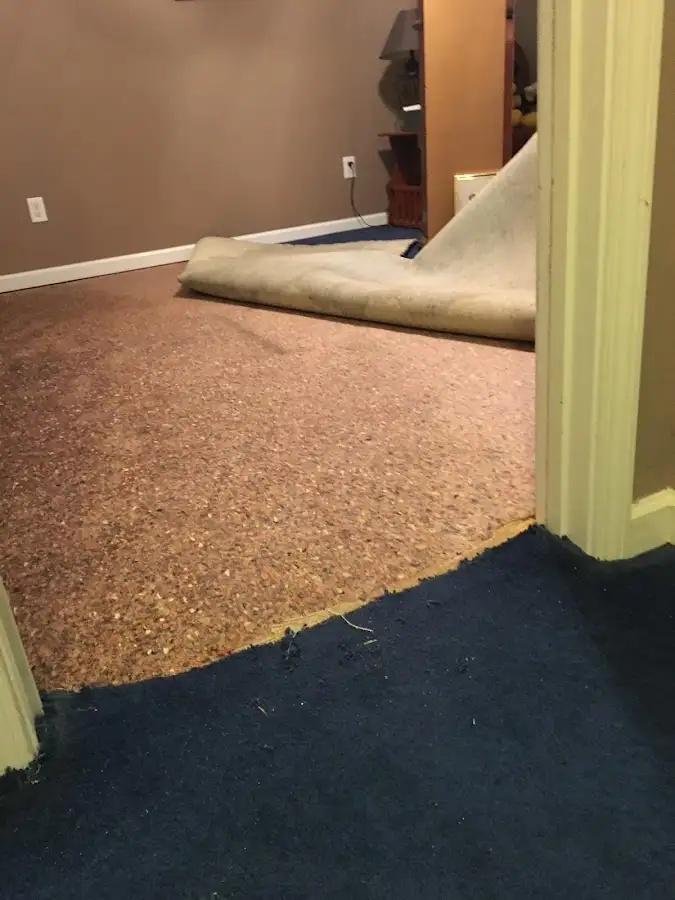 Carpet pad removal revealing water damage during Drying & Dehumidification in Dunlap